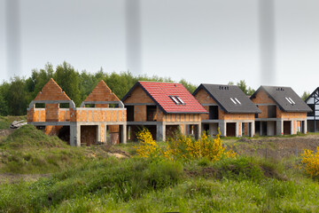 a newly built estate of single-family houses, fenced with a net