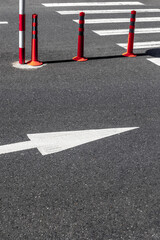 Urban street scene with pedestrian crosswalk and traffic cones