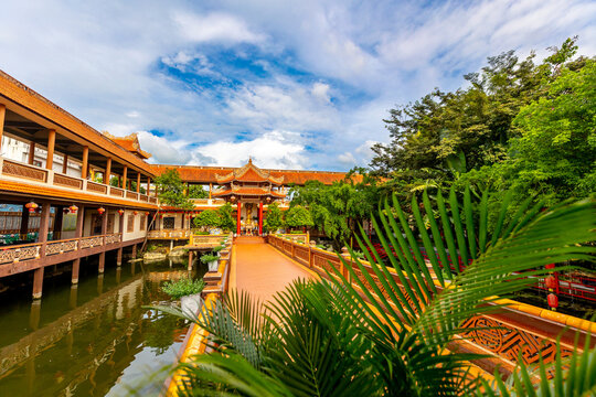 Tranquil traditional asian architecture with red roofs and lush greenery