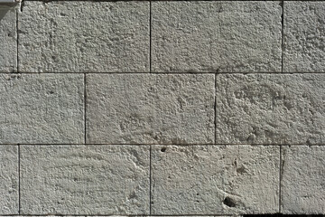 Old gray stone wall, a beautiful background for the designer, copy empty space