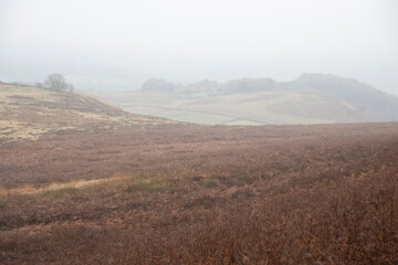 Mist descends and obscures the landscape on a foggy day in the Peak District