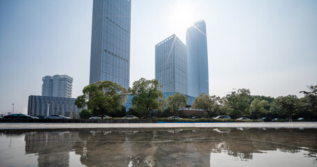 Fototapeta premium Stunning Urban Landscape with Reflective Waters Under Bright Sunlight