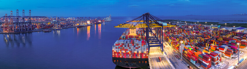 Aerial view of international cargo containers ship at industrial import-export port prepare to load...