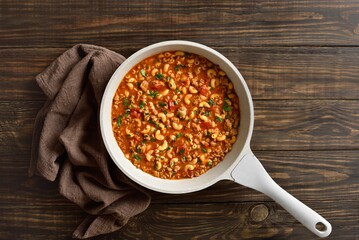 Dish with ground beef, vegetables and pasta in tomato sauce in cooking pan