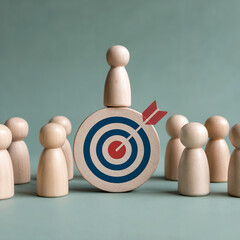 Wooden peg doll standing on a bullseye target with an arrow in it, surrounded by other wooden peg dolls. Represents success and leadership. Muted background. Overhead view