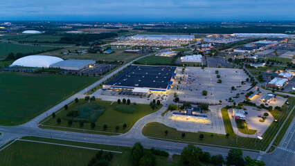  A prominent, large building with solar panels covering its roof stands 