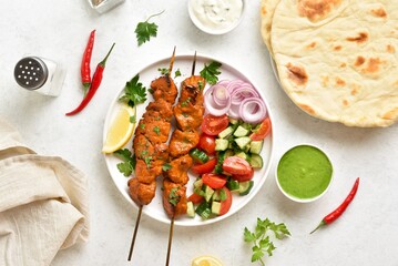 Tandoori chicken skewers served with fresh vegetables