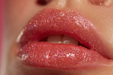 Obraz premium Close-up of glamorous woman's red lips with glitter, perfect shine, lipstick advertisement for beauty product, showing healthy, attractive makeup on a young female face