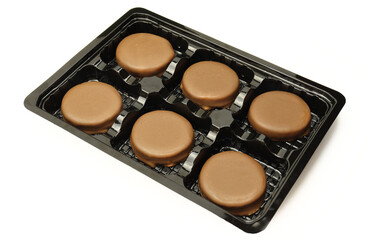 Set of chocolate cake desserts in plastic assorted isolated on white background
