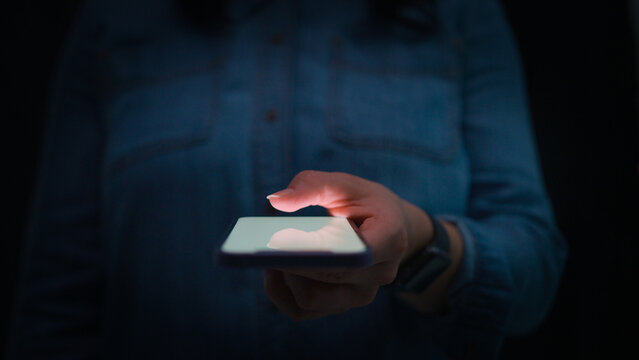 Close Up Of Woman Using Mobile Phone Text Messaging Using Thumb On Keypad