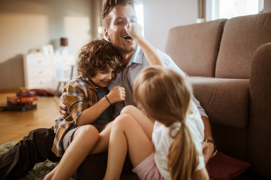 Father playing with children at home