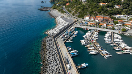 Fototapeta premium Aerial view of boats anchored in the port of Maratea, in the province of Potenza, Basilicata, Italy. It is a small marina overlooking the blue waters of the Mediterranean Sea.