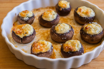 baked champignon mushrooms stuffed with herb cream cheese and topped with parmesan. Perfect for illustrating cozy fall appetizers, party snacks
