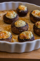 baked champignon mushrooms stuffed with herb cream cheese and topped with parmesan. Perfect for illustrating cozy fall appetizers, party snacks