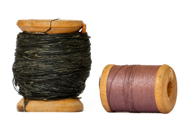 Vintage wooden thread spools on white background