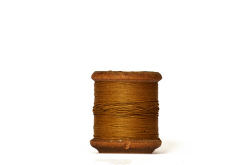 Old wooden bobbin of thread isolated on white