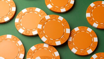 Orange poker chips on a green felt surface
