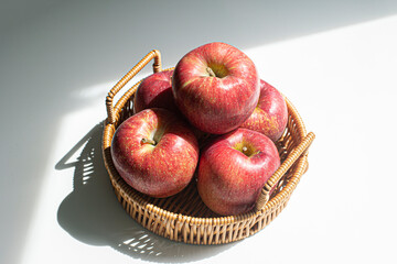 Red apples in a wicker basket.