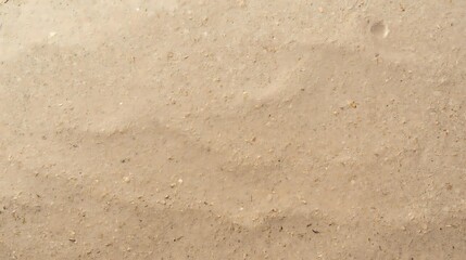 Fototapeta premium Close-up view of rippled sand dunes with fine grains and subtle textures, showcasing natural patterns formed by wind.