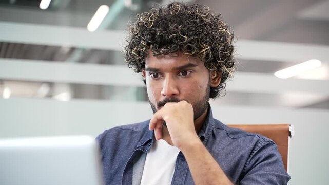 Thoughtful businessman working on laptop in business office. Manager thinking about problem solving sitting at workplace. Entrepreneur is engaged in task or is busy with project on computer. Close up