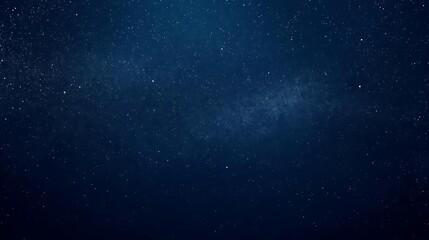Fototapeta premium A vast expanse of the night sky filled with countless twinkling stars and a faint nebula.