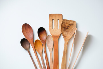 Wooden kitchen utensils isolated on white background