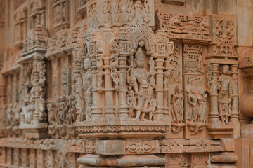 Ornate carvings on a historical temple wall, showcasing intricate details and ancient craftsmanship. Timeless art, cultural heritage and architectural wonder.
