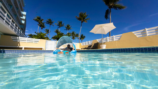 Man floating in a pool 