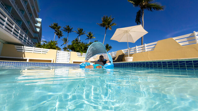 Man floating in a pool 
