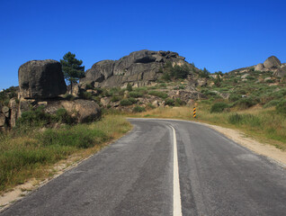 An empty secondary road winding through the Serra da Estrela mountains and natural park in the Guarda district, Beiras Region, Portugal. Mainland Portugal's highest mountains at 1993 meters.