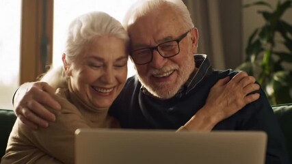 Happy senior family Caucasian couple elderly woman man talking online video call female male using laptop computer pc mature husband wife laugh cuddle hug talk internet virtual chat indoor living room - Powered by Adobe