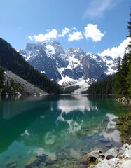 Mountain lake reflecting a bright sky