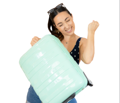 Young traveler woman holding a suitcase raising fist after a victory, winner concept. isolated over transparent background. Holidays concept.