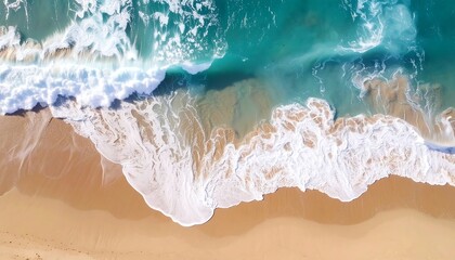 Obraz premium Aerial view of a beach with turquoise water crashing onto golden sand, creating foamy white waves
