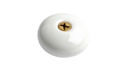 Round white ceramic object with gold screw
