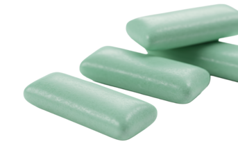 Three pristine, pastel mint green chewing gum sticks, one in sharp focus foreground, two overlapped in background, transparent with copy space, high-key lighting. Oral hygiene and fresh breath concept