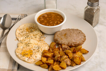 eggs over easy  with sausage patty and baked beans