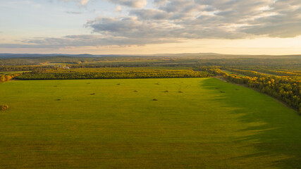 Aerial View of Green Fields, Forest and Lake at Sunset