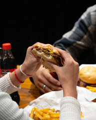 man eating hamburger