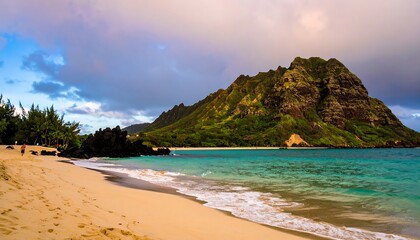 Tropical beach at dawn with dramatic mountain backdrop