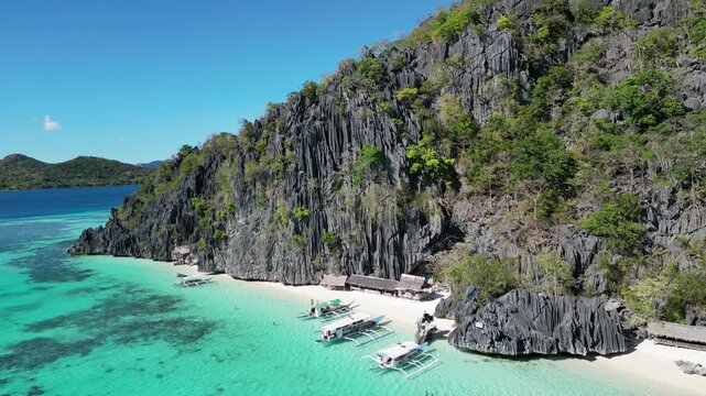 Coron, Palawa, Philippines, in South East Asia, with White Sand Beach, Turquoise Water, filmed on an Island island hopping boat tour with Limestone Cliffs in the background