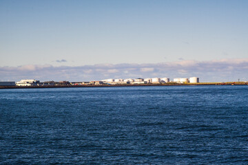 Fototapeta premium Industrial oil storage tanks by the sea
