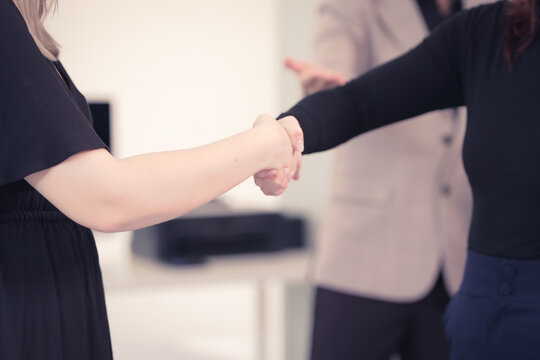 Diverse business team collaborates in modern office, discussing charts, data, strategies. Their professional teamwork reflects communication, leadership, success, productive, innovation cooperation.