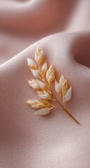 Delicate dried flower sprig on blush pink fabric