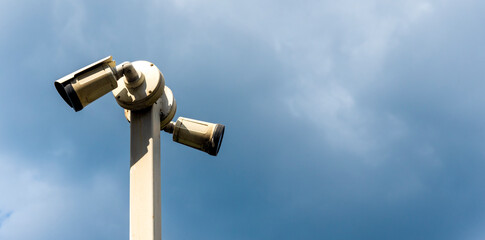 High-resolution security camera on a tall pole observing the sky in daylight