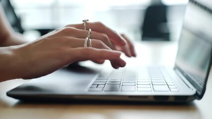 Hands typing on laptop keyboard - Powered by Adobe