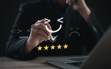 Business professional selecting happy face emoticon with five star rating on digital interface. Concept of customer satisfaction, feedback, survey, experience, and online review management.