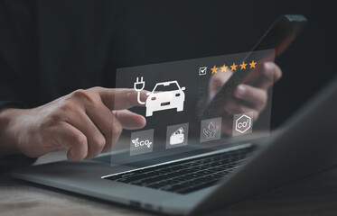 Hand pointing at electric car icon with five star rating, eco energy, and CO2 reduction symbols on digital interface. Concept of sustainable transportation, clean technology, and green innovation.