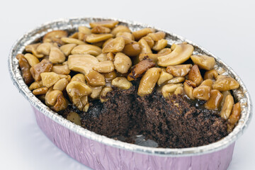 Caramel toffee cake nut chocolate dessert sweet baked snack delicious are combined in this rich chocolate cake topped with caramelized nuts creating decadent and inviting treat