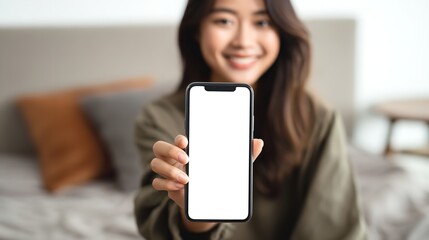 A radiant woman presenting a blank phone screen her smile reflecting boundless possibilities in a softly lit interior